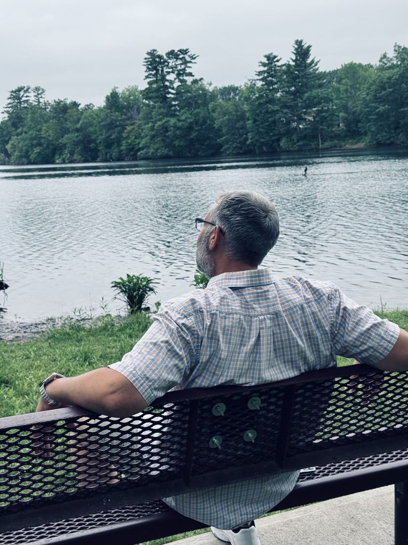 Scott sitting beside a lake